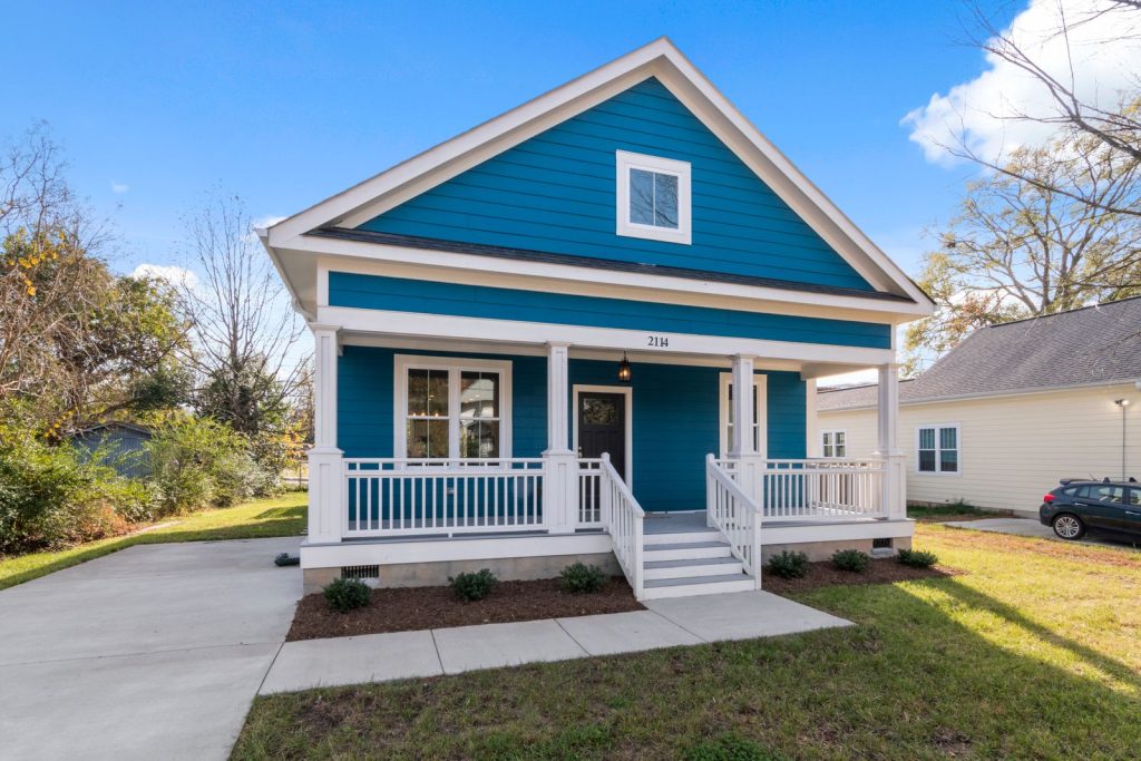 A blue house with a welcoming front porch.